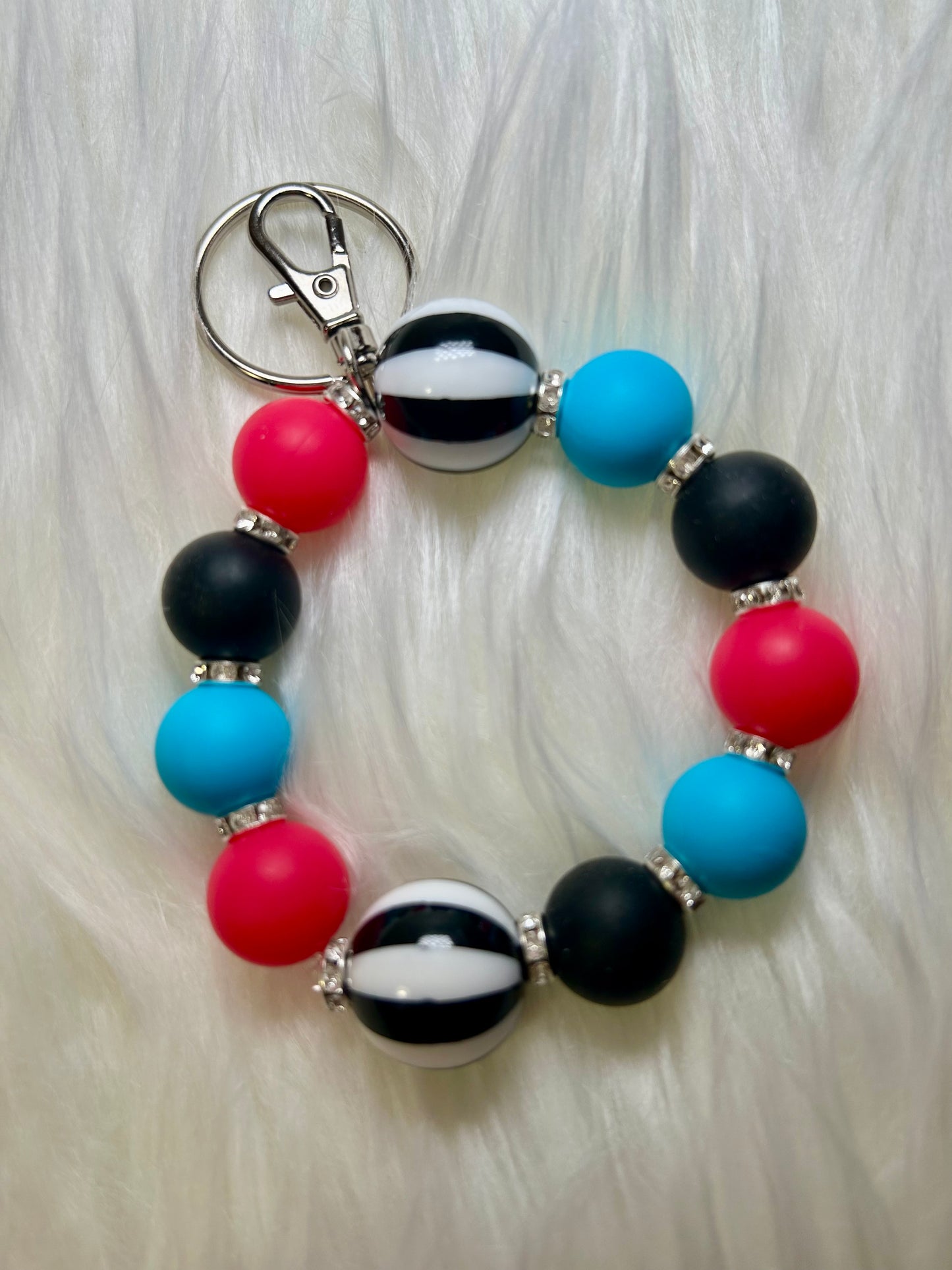 Blue, pink, and black wristlet keychain