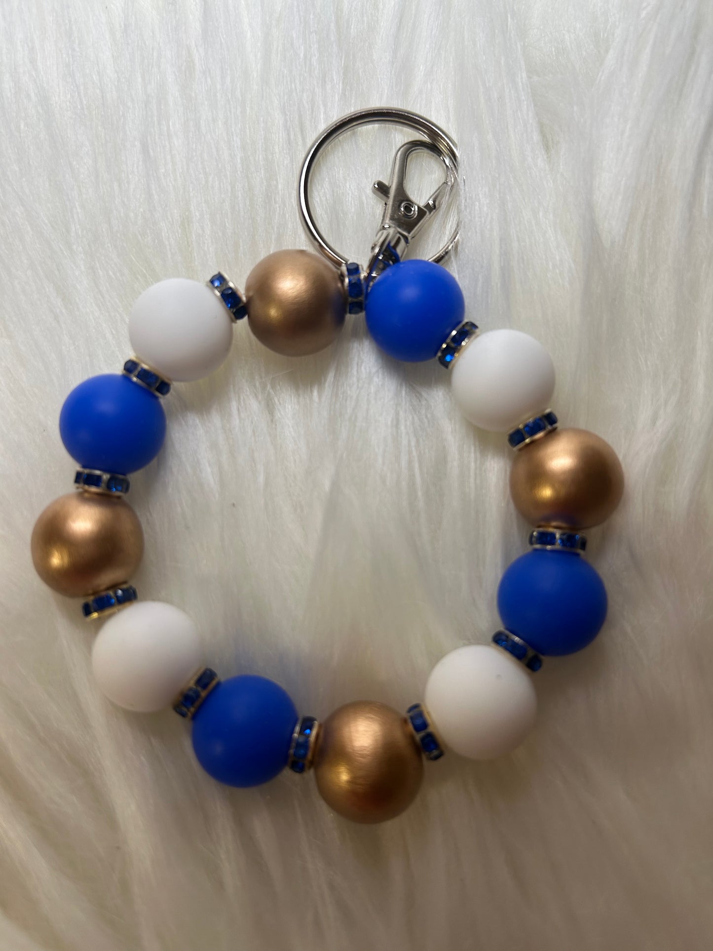 Blue, white, and gold wristlet keychain