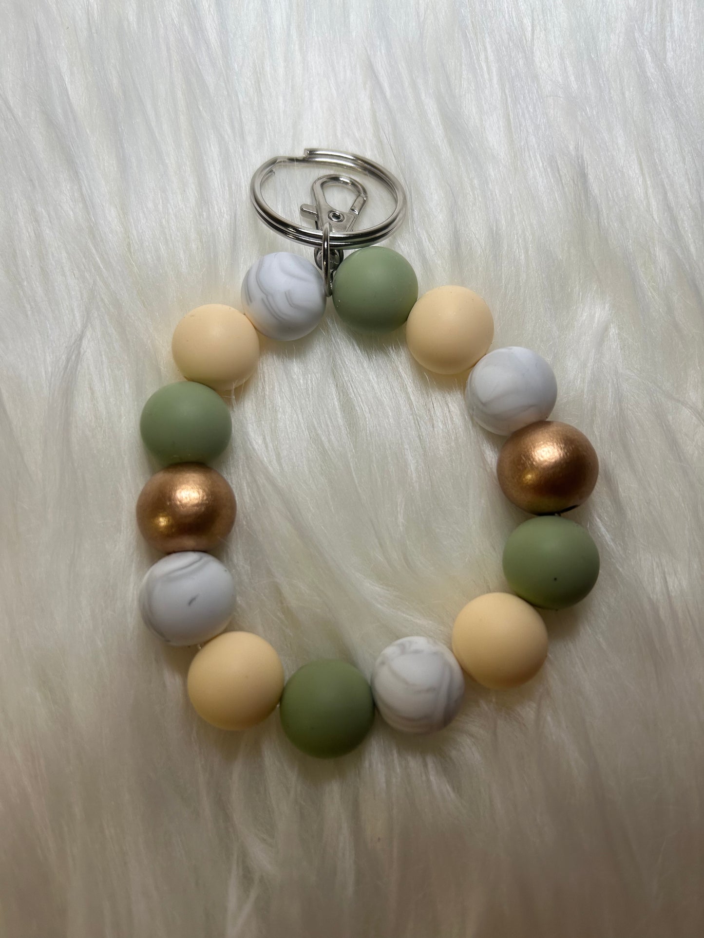 Mint green, cream, and gold wristlet keychain