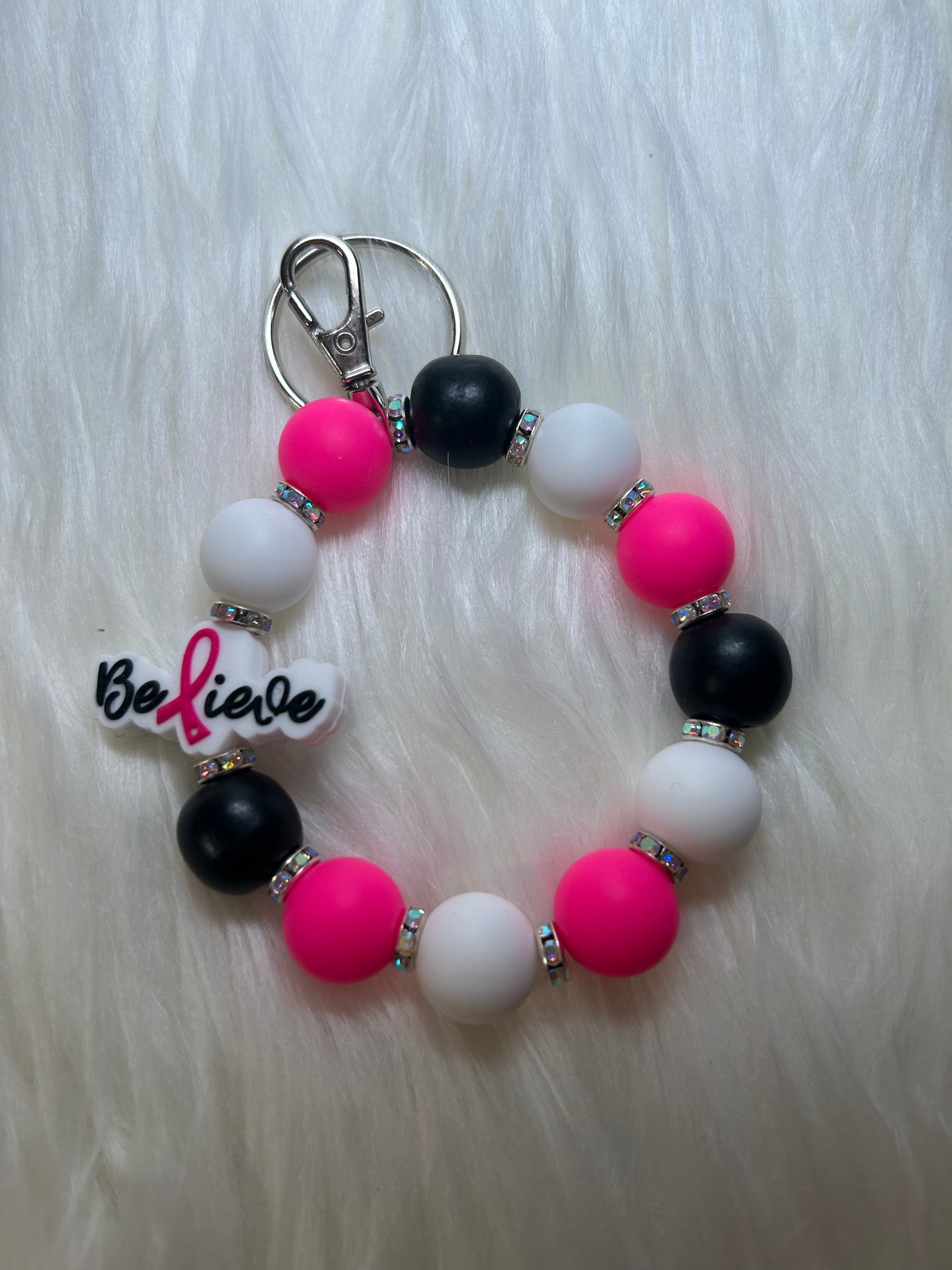 Pink, black, and white breast cancer wristlet keychain