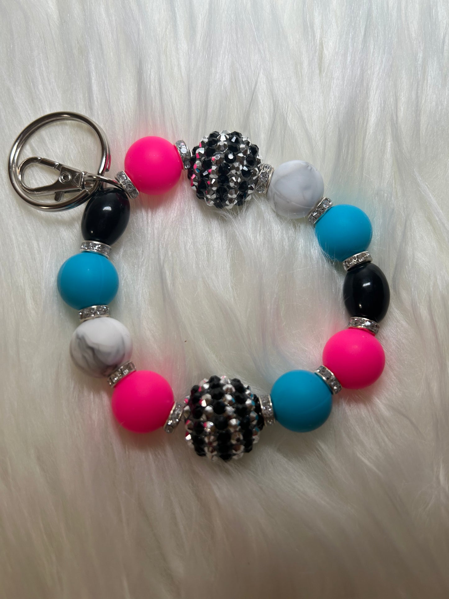 Pink, blue, black, and white wristlet keychain