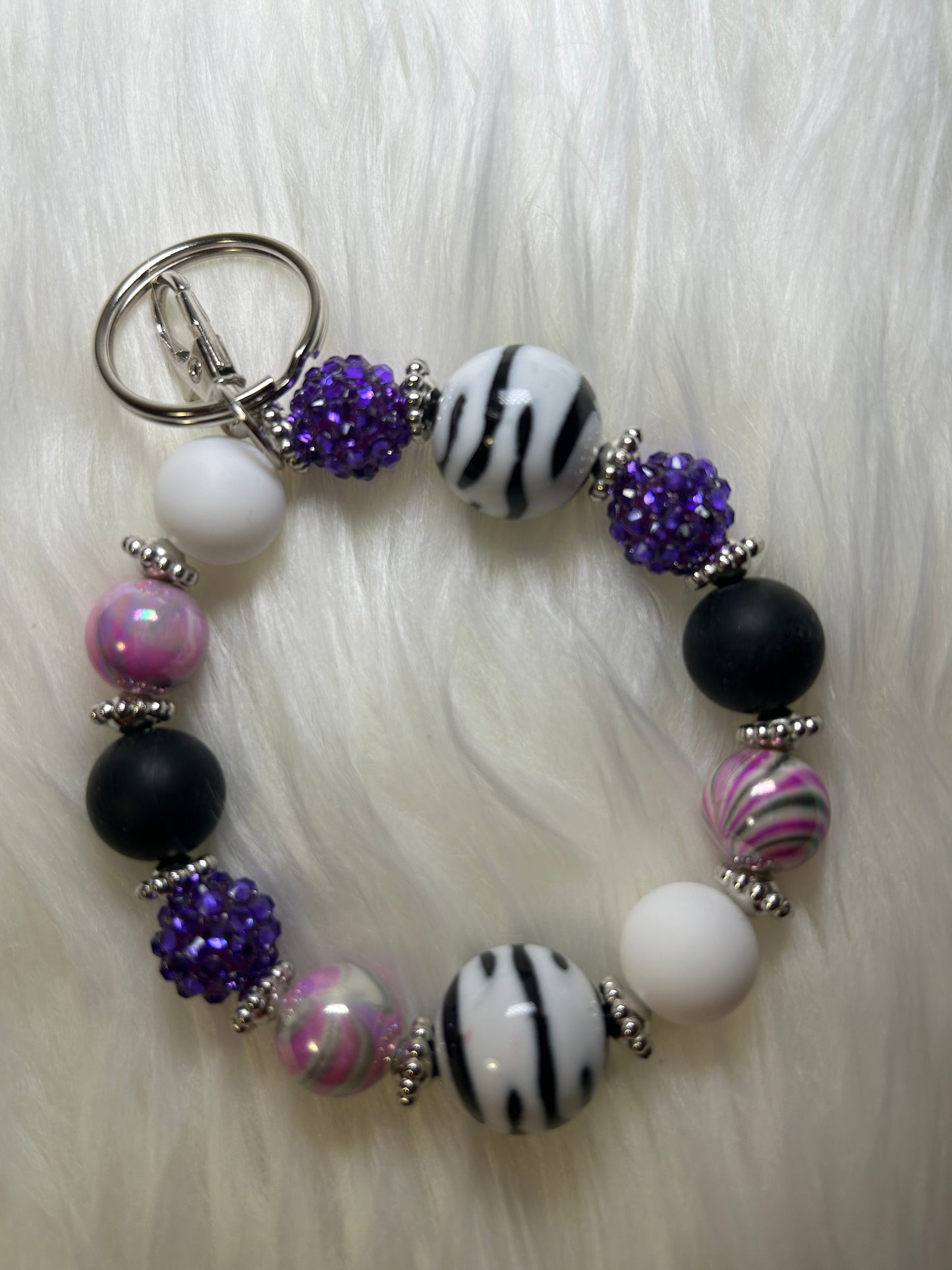 Purple, black, and white wristlet keychain