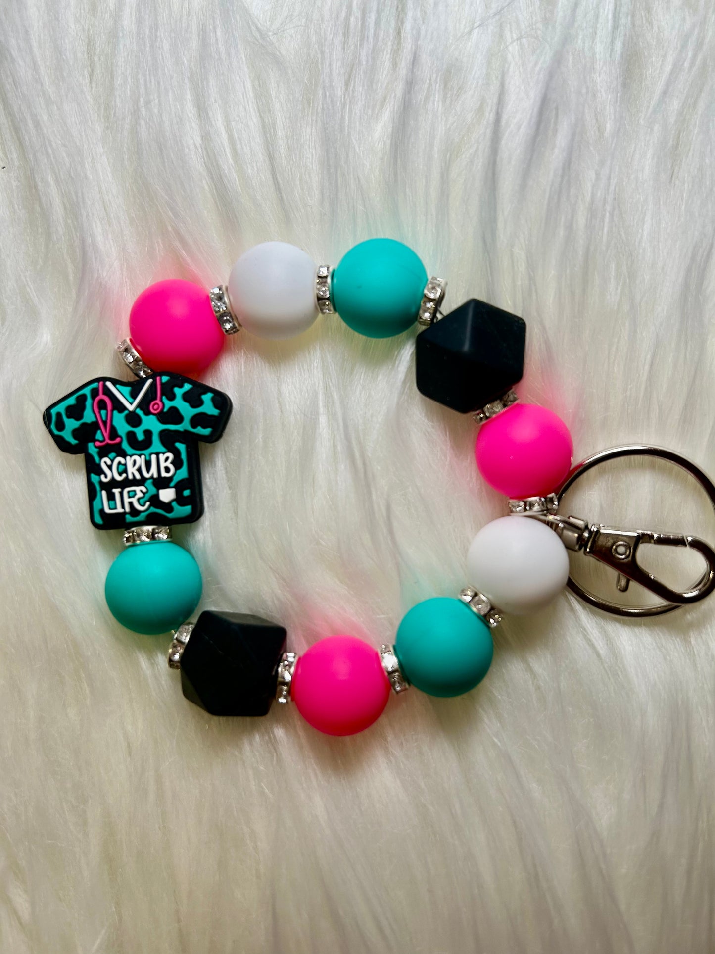 Teal, pink, and black nursing wristlet keychain