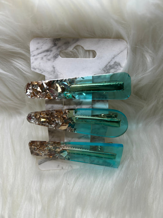 Teal and gold barrettes