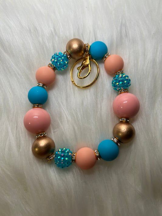 Blue, peach, and gold wristlet