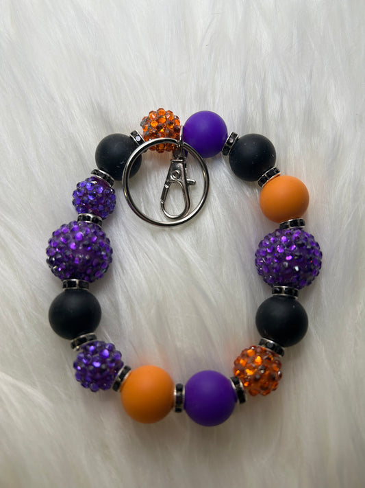 Purple, black, and orange wristlet