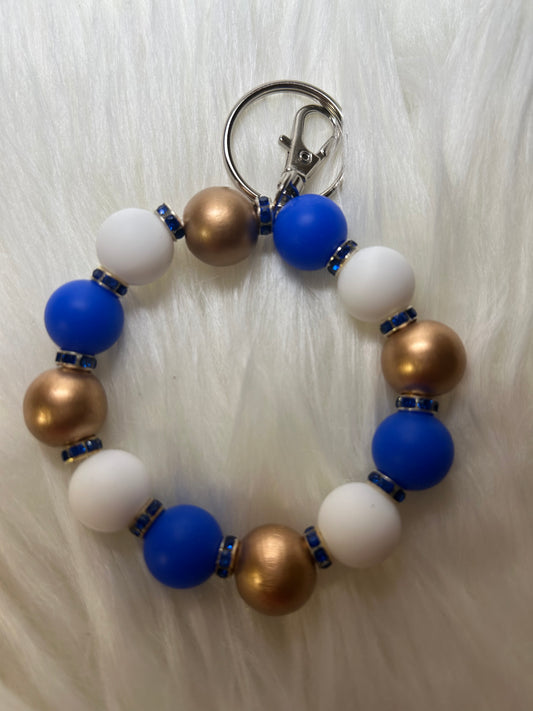 Blue, white, and gold wristlet keychain