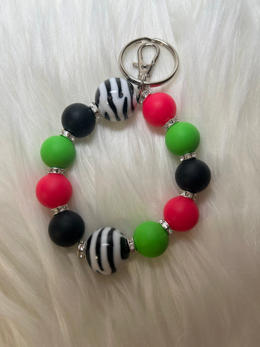 Green, pink, and black wristlet keychain