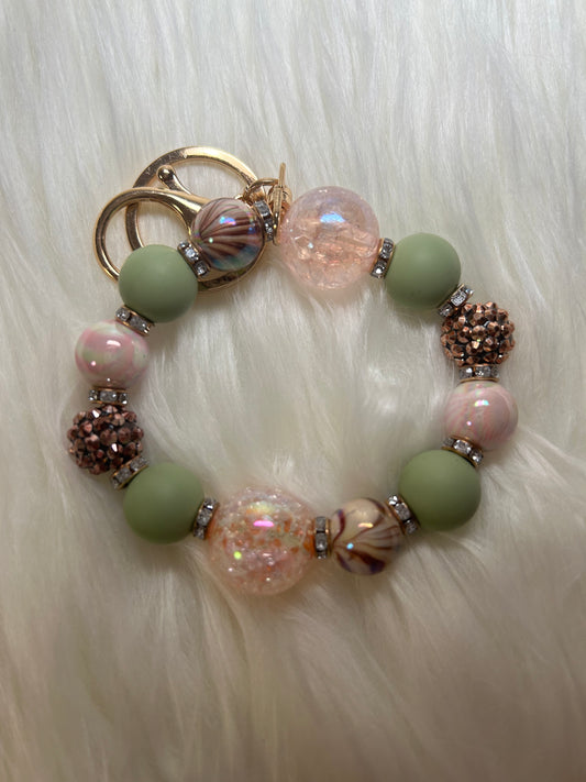 Peach, mint green, and brown wristlet keychain