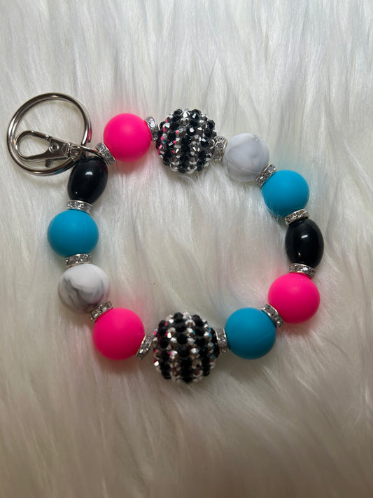 Pink, blue, black, and white wristlet keychain