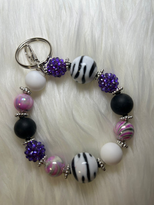 Purple, black, and white wristlet keychain