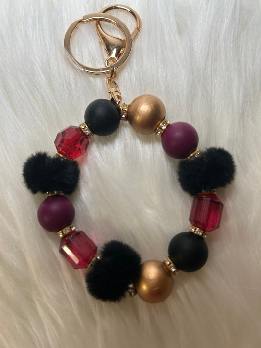 Red, black, and gold wristlet keychain