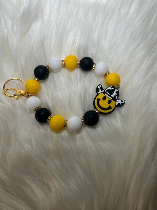 Yellow, black, and white smiley face Wristlet Keychain