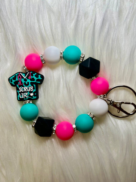 Teal, pink, and black nursing wristlet keychain
