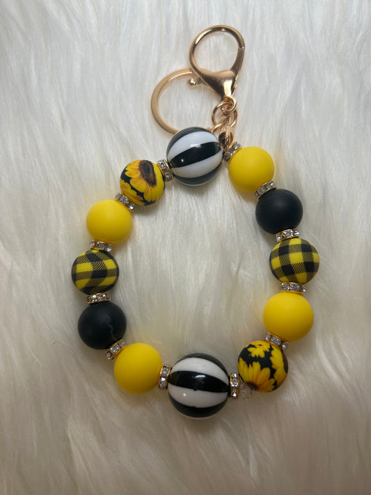 Yellow, black, and white wristlet keychain